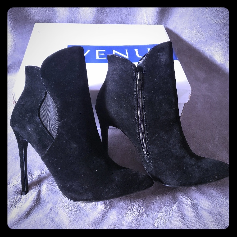Black high heel booties with a zipper on the side